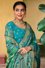 Load image into Gallery viewer, Teal Blue Zari Woven Handwork Embroidery Dola Silk Saree With Blouse